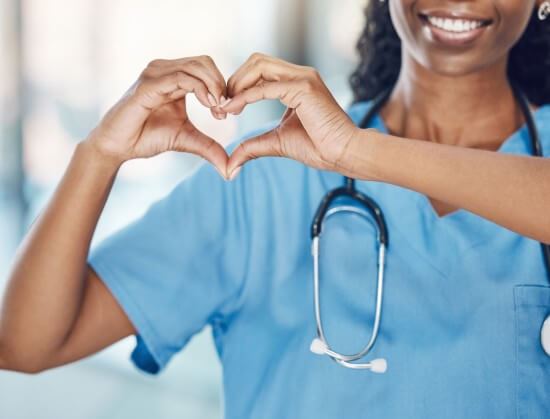 nurse making a heart with her hands